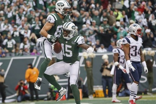 CORRECTS TO SECOND HALF NOT FIRST New York Jets wide receiver Brandon Marshall (15) and Eric Decker (87) celebrate a touchdown as New England Patriots' Leonard Johnson (34) looks on during the second half of an NFL football game, Sunday, Dec. 27, 2015, in East Rutherford, N.J. (AP Photo/Kathy Willens)