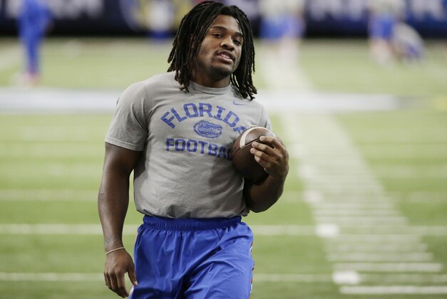 Florida running back Jordan Scarlett stretches during a team workout ahead of Saturday's Southeastern Conference championship NCAA college football game against Alabama, Friday, Dec. 4, 2015, in Atlanta. (AP Photo/David Goldman)