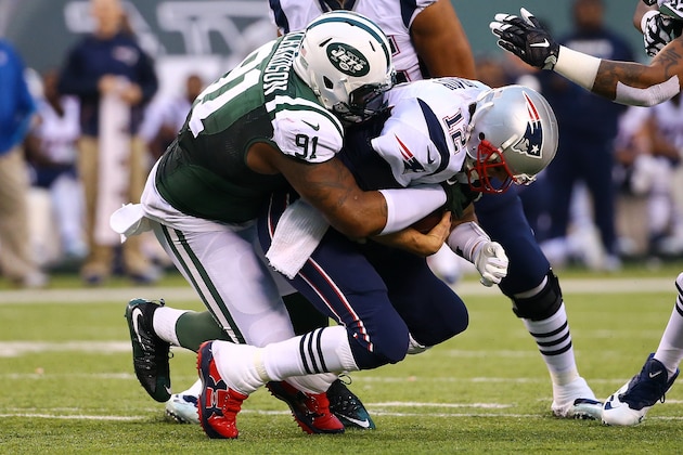 EAST RUTHERFORD, NJ - DECEMBER 27:  Sheldon Richardson #91 of the New York Jets sacks Tom Brady #12 of the New England Patriots during their game at MetLife Stadium on December 27, 2015 in East Rutherford, New Jersey.  (Photo by Al Bello/Getty Images)