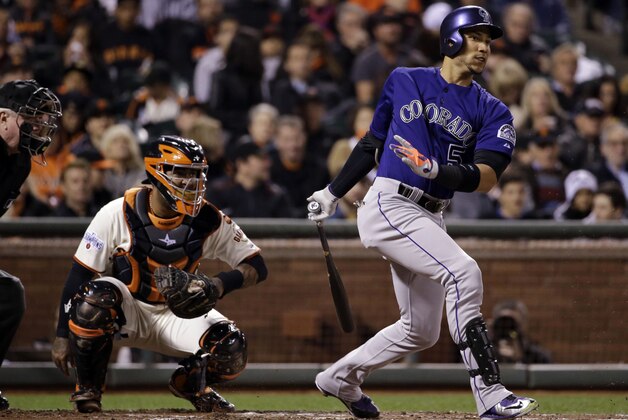 Colorado Rockies' Carlos Gonzalez singles during the third inning of a baseball game against the San Francisco Giants on Tuesday, April 14, 2015, in San Francisco. (AP Photo/Marcio Jose Sanchez)