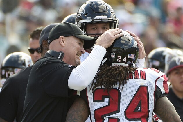 Atlanta Falcons head coach Dan Quinn congratulates running back Devonta Freeman (24) after a touchdown run against the Jacksonville Jaguars during the first half of an NFL football game in Jacksonville, Fla., Sunday, Dec. 20, 2015. (AP Photo/Phelan M. Ebenhack)