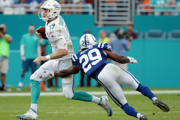 Miami Dolphins quarterback Ryan Tannehill (17) runs with the ball as Indianapolis Colts strong safety Mike Adams (29) attempts to tackle during the second half of an NFL football game, Sunday, Dec. 27, 2015, in Miami Gardens, Fla.  (AP Photo/Lynne Sladky)