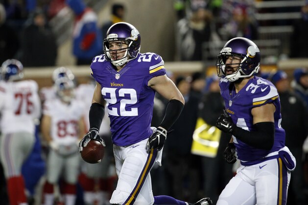 Minnesota Vikings free safety Harrison Smith (22) holds his interception that he ran back for a touchdown during the first half of an NFL football game against the New York Giants, Sunday, Dec. 27, 2015, in Minneapolis. (AP Photo/Ann Heisenfelt)