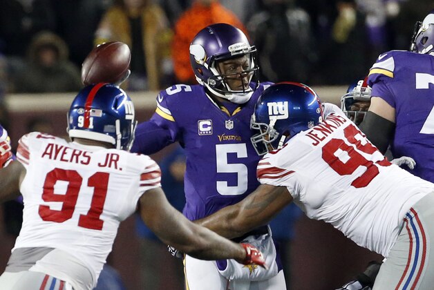Minnesota Vikings quarterback Teddy Bridgewater (5) looks to pass under pressure from New York Giants defensive end Robert Ayers (91) and defensive tackle Cullen Jenkins (99) during the first half of an NFL football game Sunday, Dec. 27, 2015, in Minneapolis. (AP Photo/Ann Heisenfelt)