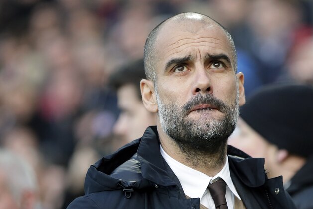 Bayern head coach Pep Guardiola arrives for the German Bundesliga soccer match between Hannover 96 and FC Bayern Munich in Hannover, Germany, Saturday, Dec. 19, 2015. (AP Photo/Michael Sohn)