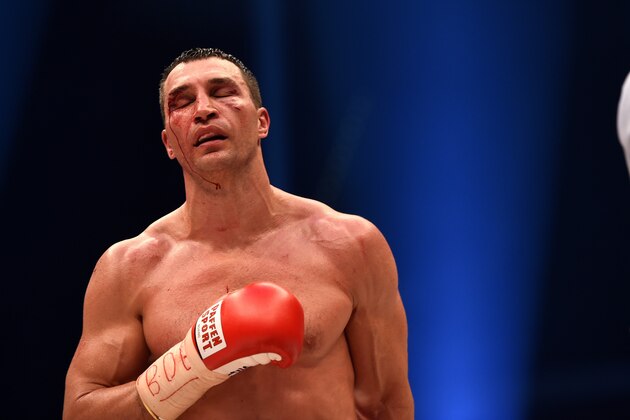 A bloodied world heavyweight boxing champion Wladimir Klitschko of Ukraine returns to his corner between rounds against Britain's Tyson Fury during their  WBA, IBF, WBO and IBO title bout in Duesseldorf, western Germany, on November 28, 2015.   Fury dethroned  Klitschko in a 12-round decision to become world heavyweight champion.  / AFP / PATRIK STOLLARZ        (Photo credit should read PATRIK STOLLARZ/AFP/Getty Images)