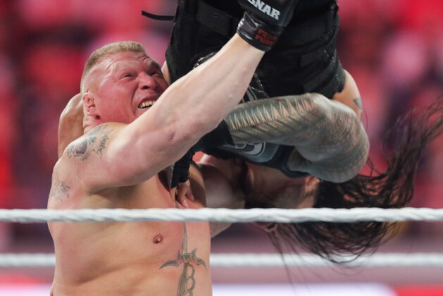Brock Lesnar upends opponent Roman Reigns at Wrestlemania XXXI, on Sunday, March 29, 2015 in Santa Clara, CA. 2015 marks the first year Wrestlemania will be held in the San Francisco Bay Area, being made available to viewers in 177 countries via the WWE Network. (Don Feria/AP Images for WWE)