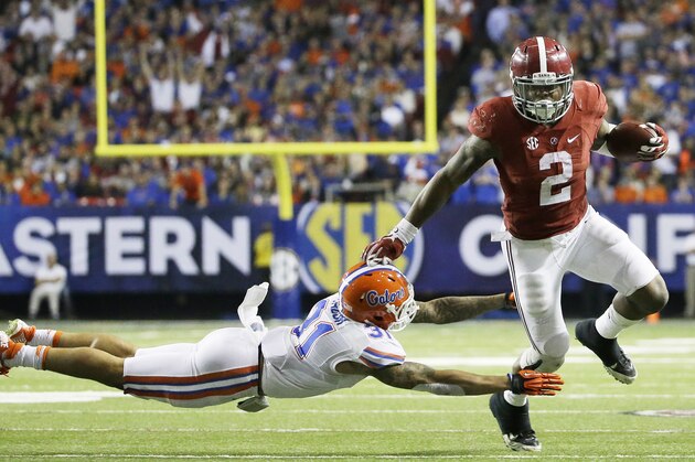 Alabama running back Derrick Henry (2) runs by Florida defensive back Jalen Tabor (31) during the second half of the Southeastern Conference championship NCAA college football game, Saturday, Dec. 5, 2015, in Atlanta. (AP Photo/David Goldman)