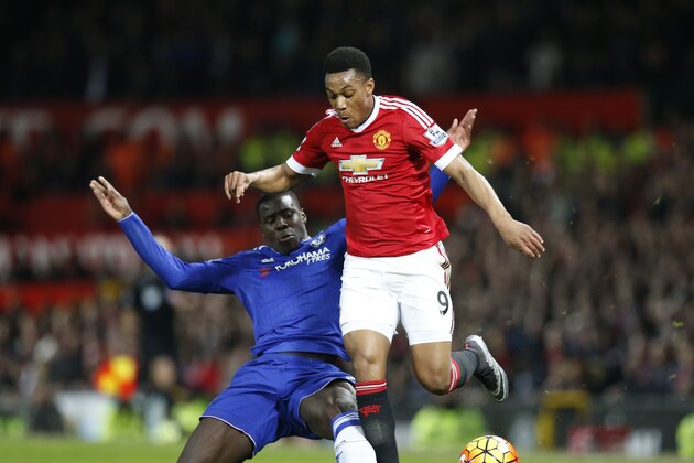 Chelsea's Kurt Zouma, left, challenges Manchester United's Anthony Martial during the English Premier League soccer match between Manchester United and Chelsea at Old Trafford Stadium, Manchester, England, Monday, Dec. 28, 2015. (AP Photo/Jon Super)