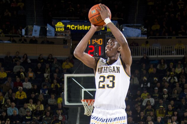 Michigan guard Caris LeVert (23) takes a three-point shot in the first half of an NCAA college basketball game against Youngstown State at Crisler Center in Ann Arbor, Mich., Saturday, Dec. 19, 2015. (AP Photo/Tony Ding)