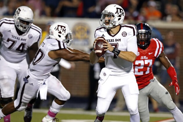 Texas A&M quarterback Jake Hubenak (7) looks for an open receiver while his teammates try to keep Mississippi defensive end Marquis Haynes (27) from rushing the pass during the second half of their NCAA college football game in Oxford, Miss., Saturday, Oct. 24, 2015. No. 24 Mississippi won 23-3. (AP Photo/Rogelio V. Solis)