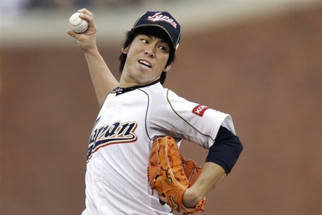 Japan's Kenta Maeda pitches during the first inning of a semifinal game of the World Baseball Classic against Puerto Rico in San Francisco, Sunday, March 17, 2013. (AP Photo/Ben Margot)
