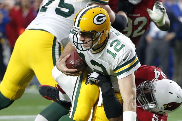 Green Bay Packers quarterback Aaron Rodgers (12) is sacked by Arizona Cardinals inside linebacker Dwight Freeney during the second half of an NFL football game, Sunday, Dec. 27, 2015, in Glendale, Ariz. (AP Photo/Ross D. Franklin)