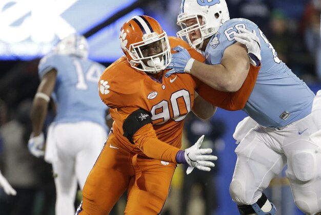 Clemson's Shaq Lawson (90) is blocked by North Carolina's Lucas Crowley (68) as North Carolina quarterback Marquise Williams (12) passes during the first half of the Atlantic Coast Conference championship NCAA college football game in Charlotte, N.C., Saturday, Dec. 5, 2015. (AP Photo/Bob Leverone)