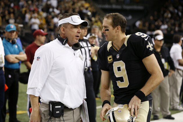 New Orleans Saints head coach Sean Payton talks to quarterback Drew Brees (9) before an NFL football game against the Jacksonville Jaguars in New Orleans, Sunday, Dec. 27, 2015. (AP Photo/Jonathan Bachman)