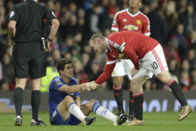 Manchester United's English striker Wayne Rooney (R) helps up Chelsea's Brazilian midfielder Oscar (C) after fouling him in a challenge that earned Rooney a yellow card during the English Premier League football match between Manchester United and Chelsea at Old Trafford in Manchester, north west England, on December 28, 2015. AFP PHOTO / OLI SCARFF

RESTRICTED TO EDITORIAL USE. No use with unauthorized audio, video, data, fixture lists, club/league logos or 'live' services. Online in-match use limited to 75 images, no video emulation. No use in betting, games or single club/league/player publications. / AFP / OLI SCARFF        (Photo credit should read OLI SCARFF/AFP/Getty Images)