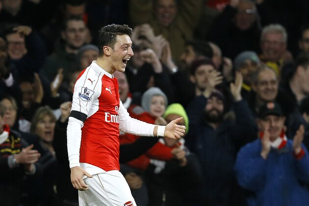 Arsenal's Mesut Ozil celebrates after scoring a goal,  during the English Premier League soccer match between Arsenal and Bournemouth at Emirates stadium in London, Monday, Dec. 28, 2015. (AP Photo/Kirsty Wigglesworth)