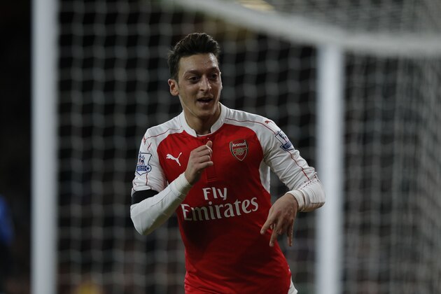 Arsenal's German midfielder Mesut Ozil celebrates after scoring their second goal during the English Premier League football match between Arsenal and Bournemouth at the Emirates Stadium in London on December 28, 2015. AFP PHOTO / ADRIAN DENNIS

RESTRICTED TO EDITORIAL USE. No use with unauthorized audio, video, data, fixture lists, club/league logos or 'live' services. Online in-match use limited to 75 images, no video emulation. No use in betting, games or single club/league/player publications. / AFP / ADRIAN DENNIS        (Photo credit should read ADRIAN DENNIS/AFP/Getty Images)