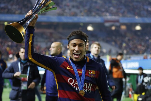FC Barcelona's Neymar holds a trophy after winning the final match against River Plate at the FIFA Club World Cup soccer tournament in Yokohama, near Tokyo, Sunday, Dec. 20, 2015. (AP Photo/Shuji Kajiyama)
