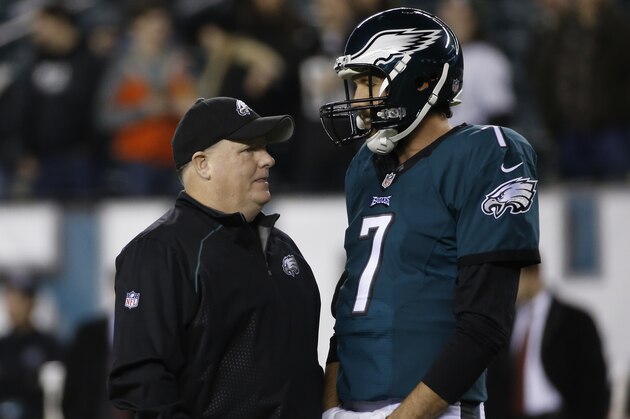Philadelphia Eagles head coach Chip Kelly, left, meets with quarterback Sam Bradford before an NFL football game against the Washington Redskins, Saturday, Dec. 26, 2015, in Philadelphia.  (AP Photo/Michael Perez)