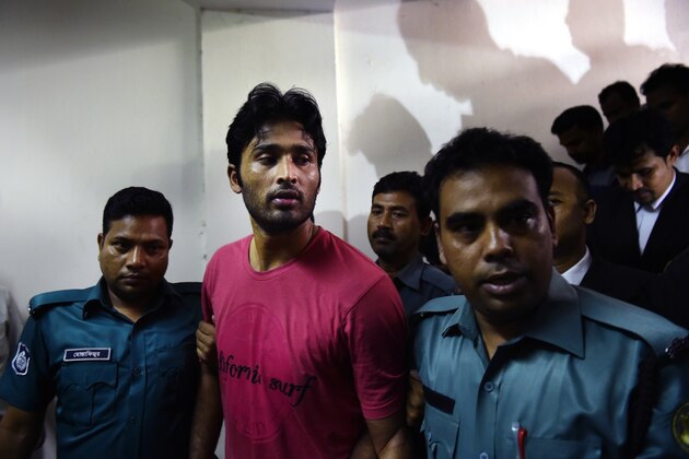 Bangladeshi security personnel escort fugitive cricketer Shahadat Hossain (C) after he surrendered in Dhaka on October 5, 2015. Hossain was remanded in jail on October 5 shortly after he surrendered to a court over allegations of beating his 11-year-old maid, his lawyer said. AFP PHOTO / MUNIR UZ ZAMAN        (Photo credit should read MUNIR UZ ZAMAN/AFP/Getty Images)