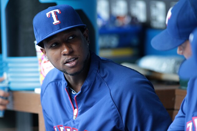 ARLINGTON, TX - AUGUST 14:Jurickson Profar #13 of the Texas Rangers looks on from the dugout before the start of the game against the Tampa Bay Rays at Globe Life Park in Arlington on August 14, 2014 in Arlington, Texas.  (Photo by Rick Yeatts/Getty Images)