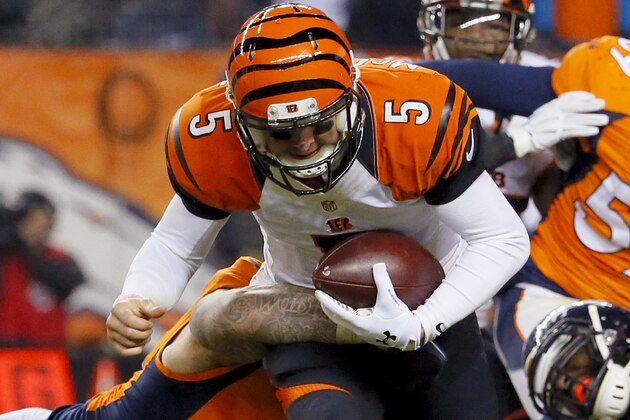 Cincinnati Bengals quarterback AJ McCarron (5) is tackled by Denver Broncos defensive end Derek Wolfe (95) during the second half of an NFL football game, Monday, Dec. 28, 2015, in Denver. (AP Photo/Jack Dempsey)
