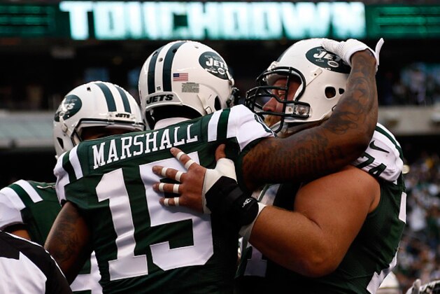 EAST RUTHERFORD, NJ - DECEMBER 27:  Brandon Marshall #15 of the New York Jets celebrates with his teammates after scoring a touchdown in the second quarter against the New England Patriots during their game at MetLife Stadium on December 27, 2015 in East Rutherford, New Jersey.  (Photo by Jeff Zelevansky/Getty Images)