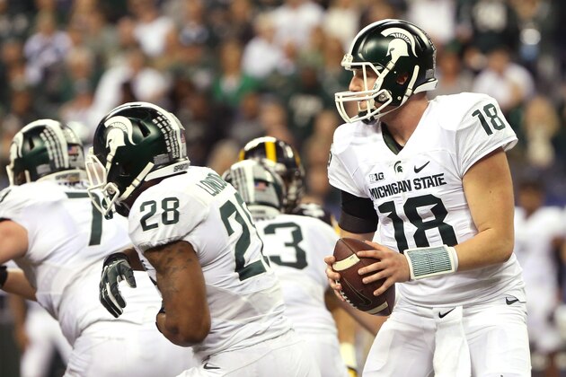 Dec 5, 2015; Indianapolis, IN, USA; Michigan State Spartans quarterback Connor Cook (18) looks to pass during the fourth quarter against the Iowa Hawkeyes in the Big Ten Conference football championship game at Lucas Oil Stadium. Mandatory Credit: Aaron Doster-USA TODAY Sports