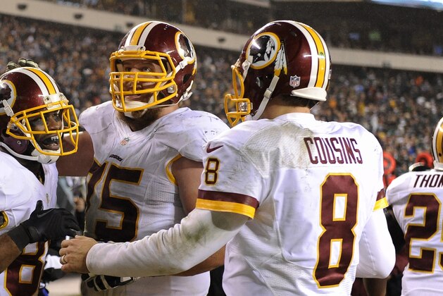 Washington Redskins' Pierre Garcon (88), Brandon Scherff (75) and Kirk Cousins (8) celebrate after a touchdown in the second half of an NFL football game against the Philadelphia Eagles, Saturday, Dec. 26, 2015, in Philadelphia.  (AP Photo/Michael Perez)