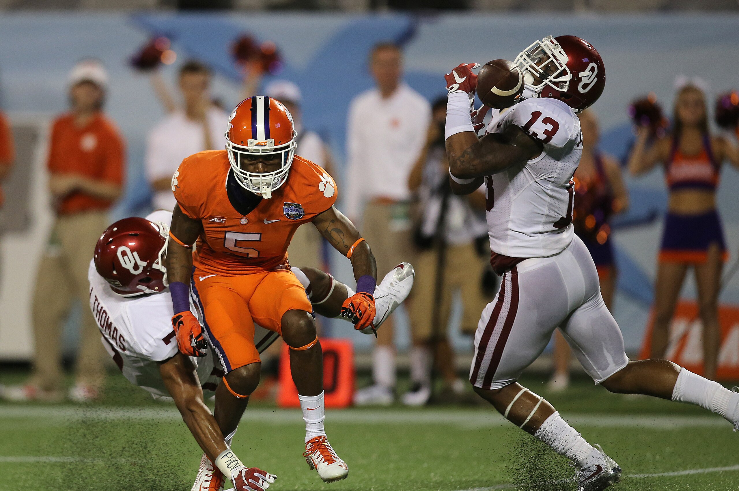 ORLANDO, FL - DECEMBER 29:  Jordan Thomas #7 of the Oklahoma Sooners breaks up a pass intended for Germone Hopper #5 of the Clemson Tigers as Ahmad Thomas #13 misses the interception during the NCAA Russell Athletic Bowl on December 29, 2014 in Orlando, Florida. Clemson won the game by a score of 40-6. (Photo by Alex Menendez/Getty Images)