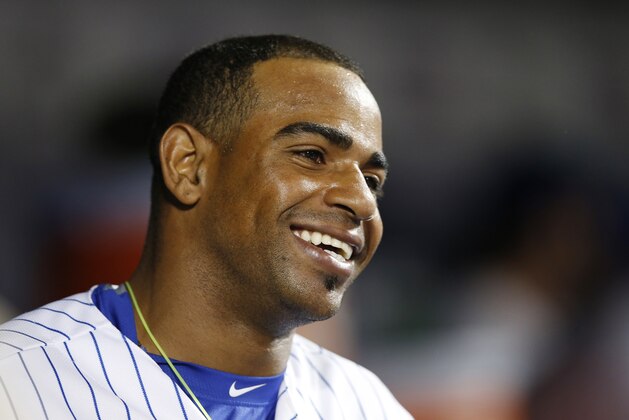 New York Mets Yoenis Cespedes smiles in the dugout after hiting a third-inning, solo, home run in a baseball game against the Miami Marlins in New York, Monday, Sept. 14, 2015. (AP Photo/Kathy Willens)