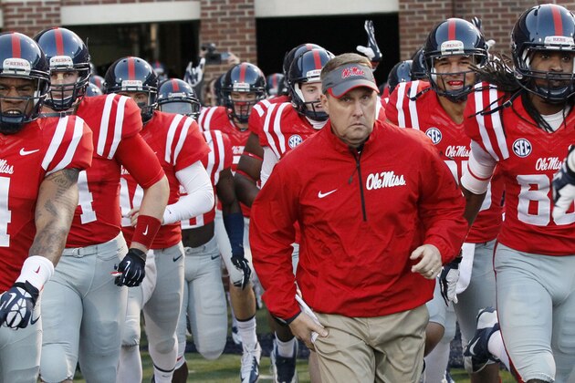 FILE - In this Oct. 19, 2013, file photo, Mississippi football coach Hugh Freeze leads his team to the field prior to their NCAA college football game against LSU  in Oxford, Miss. Mississippi has aspirations of competing for SEC titles. No. 11 Ole Miss (4-0, 1-0) plays No. 3 Alabama (4-0, 1-0) on Saturday, Oct. 4, 2014,  in its biggest home game in more than a decade.  (AP Photo/Rogelio V. Solis, File)