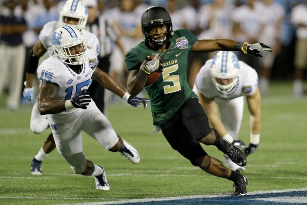 Baylor running back Johnny Jefferson (5) runs for a touchdown past the North Carolina defense including safety Donnie Miles (15) during the first half of the Russell Athletic Bowl NCAA college football game, Tuesday, Dec. 29, 2015, in Orlando, Fla. (AP Photo/John Raoux)