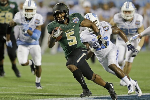 Baylor running back Johnny Jefferson (5) runs past North Carolina cornerback M.J. Stewart (6) and safety Donnie Miles, right, for a 27-yard touchdown run during the first half of the Russell Athletic Bowl NCAA college football game, Tuesday, Dec. 29, 2015, in Orlando, Fla. (AP Photo/John Raoux)