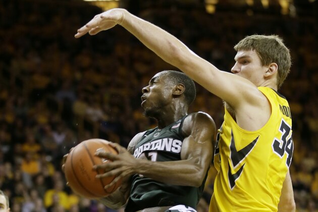 Michigan State guard Lourawls Nairn Jr. drives to the basket past Iowa center Adam Woodbury, right, during the first half of an NCAA college basketball game Tuesday, Dec. 29, 2015, in Iowa City, Iowa. (AP Photo/Charlie Neibergall)