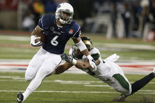 Nevada running back Don Jackson (6) breaks the tackle on Colorado State linebacker Kevin Davis during the first half of the Arizona Bowl NCAA college football game Tuesday, Dec. 29, 2015, in Tucson, Ariz. (AP Photo/Rick Scuteri)