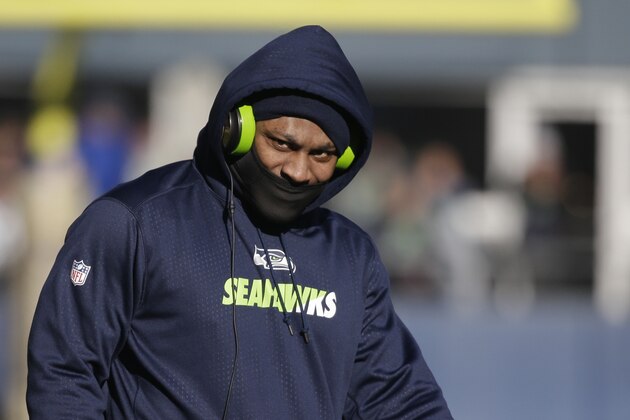 Seattle Seahawks running back Marshawn Lynch wears a mask during during warmups before an NFL football game against the San Francisco 49ers, Sunday, Nov. 22, 2015, in Seattle. (AP Photo/Elaine Thompson)