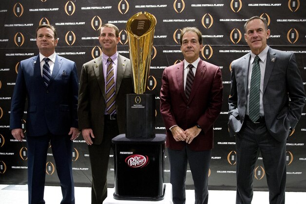 College football playoff coaches from left; Bob Stoops, of Oklahoma, Dabo Swenney, of Clemson, Nick Saban, of Alabama and Mark  Dontonio, of Michigan St., pose with the championship trophy after a news conference the college football awards at the College Football Hall of Fame  Thursday, Dec. 10, 2015, in Atlanta. Oklahoma and Clemson will meet in the Orange Bowl and Alabama and Michigan St. will play in the Cotton Bowl. (AP Photo/John Bazemore)