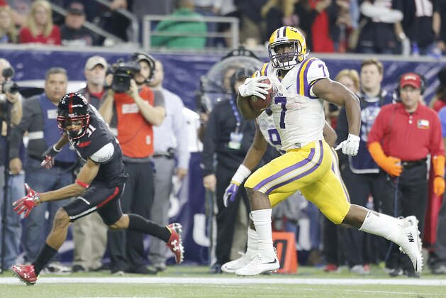 Dec 29, 2015; Houston, TX, USA; LSU Tigers running back Leonard Fournette (7) catches the ball and runs for a touchdown against the Texas Tech Red Raiders in the second quarter at NRG Stadium. Mandatory Credit: Thomas B. Shea-USA TODAY Sports