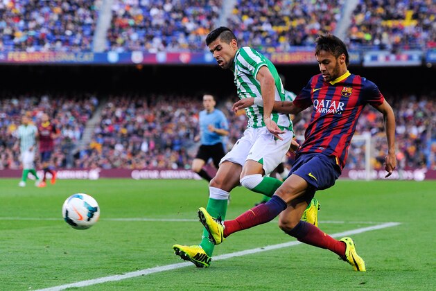 BARCELONA, SPAIN - APRIL 05: Neymar of FC Barcelona shoots towards goal under a challenge by 'Juanfran' Moreno of Real Betis Balompie during the La Liga match between FC Barcelona and Real Betis Balompie at Camp Nou on April 5, 2014 in Barcelona, Spain.  (Photo by David Ramos/Getty Images)