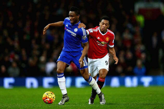 MANCHESTER, ENGLAND - DECEMBER 28:  John Obi Mikel of Chelsea holds off a challenge from Anthony Martial of Manchester United during the Barclays Premier League match between Manchester United and Chelsea at Old Trafford on December 28, 2015 in Manchester, England.  (Photo by Clive Mason/Getty Images)