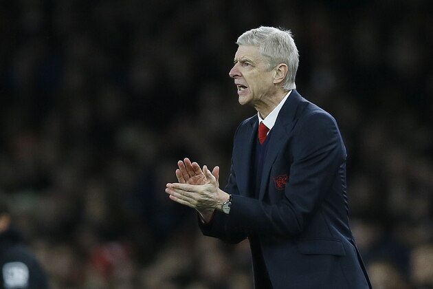 Arsenal's manager Arsene Wenger applauds his players during the English Premier League soccer match between Arsenal and Bournemouth at Emirates stadium in London, Monday, Dec. 28, 2015. (AP Photo/Kirsty Wigglesworth)