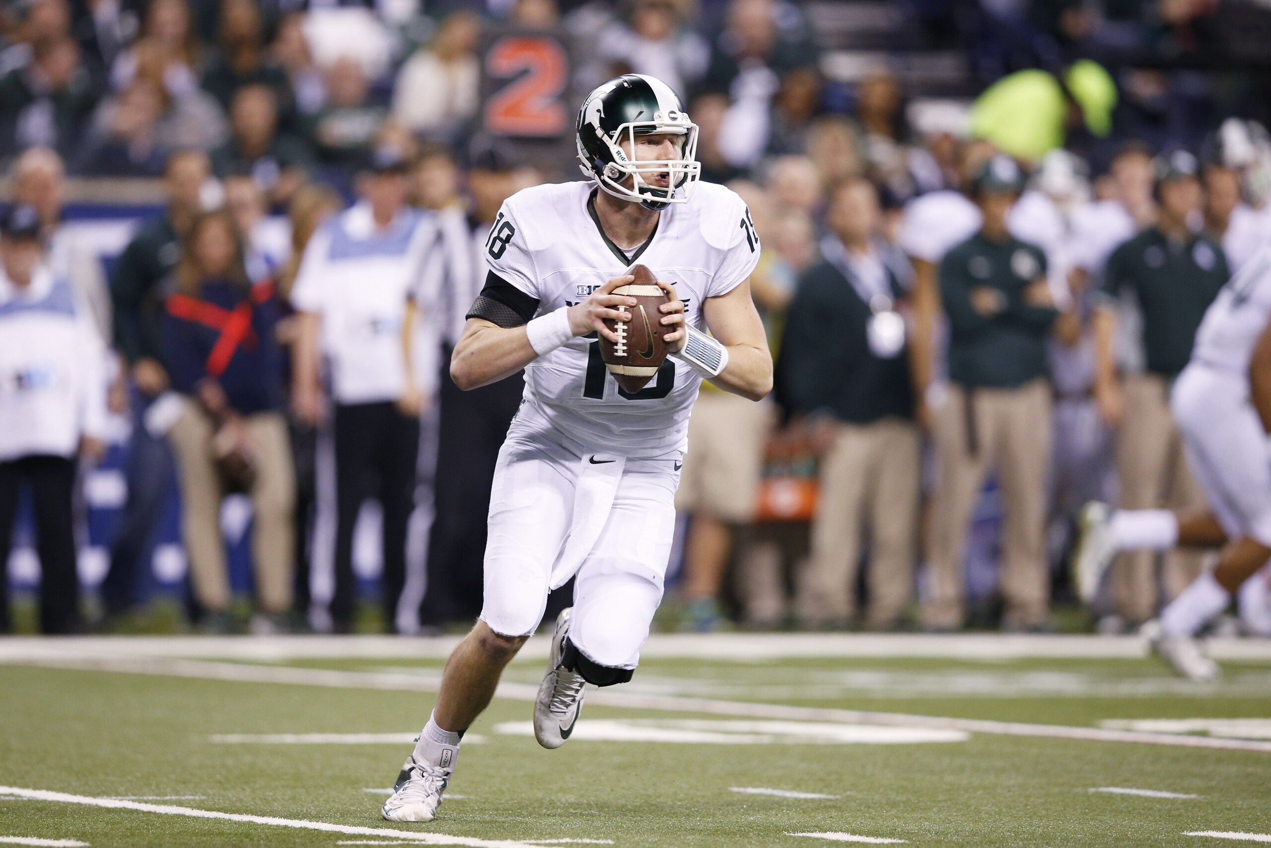 INDIANAPOLIS, IN - DECEMBER 5: Connor Cook #18 of the Michigan State Spartans looks to pass against the Iowa Hawkeyes during the Big Ten Championship at Lucas Oil Stadium on December 5, 2015 in Indianapolis, Indiana. Michigan State defeated Iowa 16-13. (Photo by Joe Robbins/Getty Images)