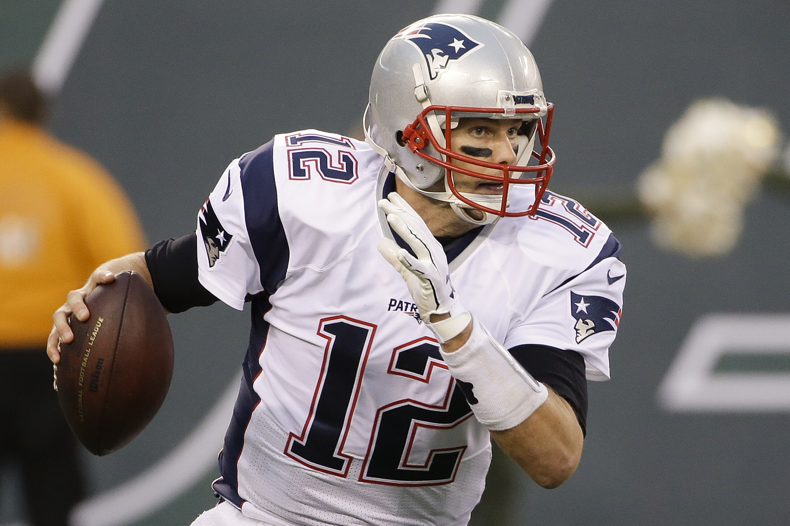 New England Patriots' Tom Brady (12) avoids the rush during the second half of an NFL football game against the New York Jets Sunday, Dec. 27, 2015, in East Rutherford, N.J. (AP Photo/Seth Wenig)