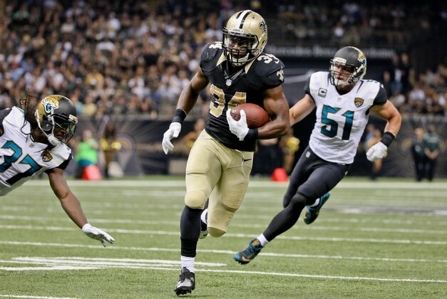 Dec 27, 2015; New Orleans, LA, USA; New Orleans Saints running back Tim Hightower (34) runs past Jacksonville Jaguars middle linebacker Paul Posluszny (51) during the second quarter of a game at the Mercedes-Benz Superdome. Mandatory Credit: Derick E. Hingle-USA TODAY Sports
