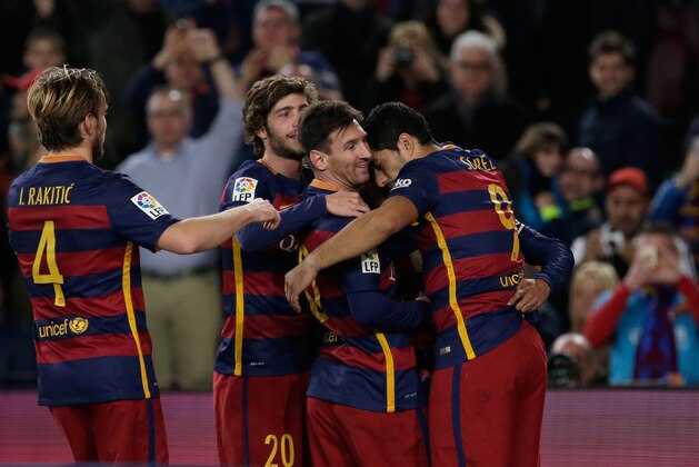 Barcelona players celebrate after Lionel Messi, from Argentina, 2nd right, scored their side’s second goal against Betis during a Spanish La Liga soccer match at the Camp Nou stadium in Barcelona, Spain, Wednesday, Dec. 30, 2015. (AP Photo/Emilio Morenatti)