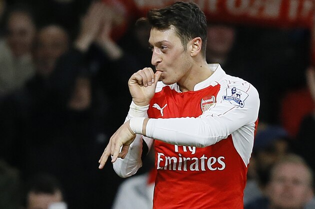 Arsenal's Mesut Ozil celebrates scoring a goal during the English Premier League soccer match between Arsenal and Bournemouth at Emirates stadium in London, Monday, Dec. 28, 2015. (AP Photo/Kirsty Wigglesworth)