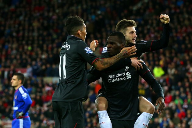 SUNDERLAND, ENGLAND - DECEMBER 30:  Christian Benteke of Liverpool celebrates with team-mate Adam Lallana and Roberto Firmino of Liverpool as Vito Mannone of Sunderland shows his dejection during the Barclays Premier League match between Sunderland and Liverpool at Stadium of Light on December 30, 2015 in Sunderland, England.  (Photo by Ian MacNicol/Getty Images)