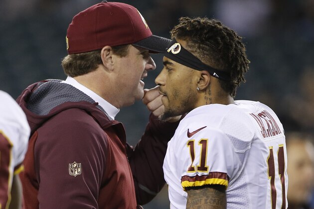 Washington Redskins head coach Jay Gruden, left, meets with DeSean Jackson before an NFL football game against the Philadelphia Eagles, Saturday, Dec. 26, 2015, in Philadelphia.  (AP Photo/Matt Rourke)